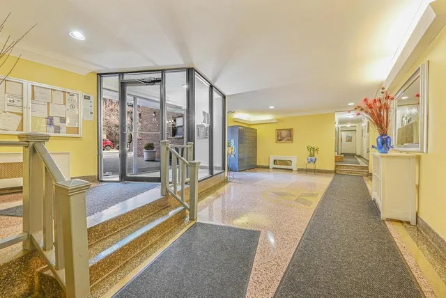 a spacious bedroom with a bed and a chandelier