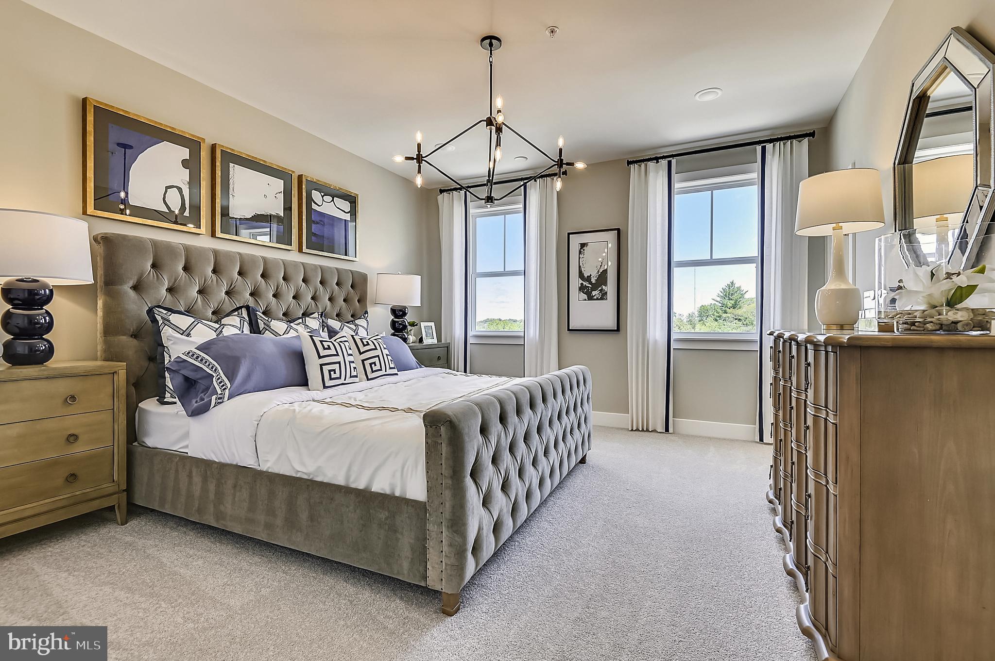 16605 Breezeway Alley Accokeek, MD 20607 - Photo 28 of 34 a bed room with a bed and a chandelier