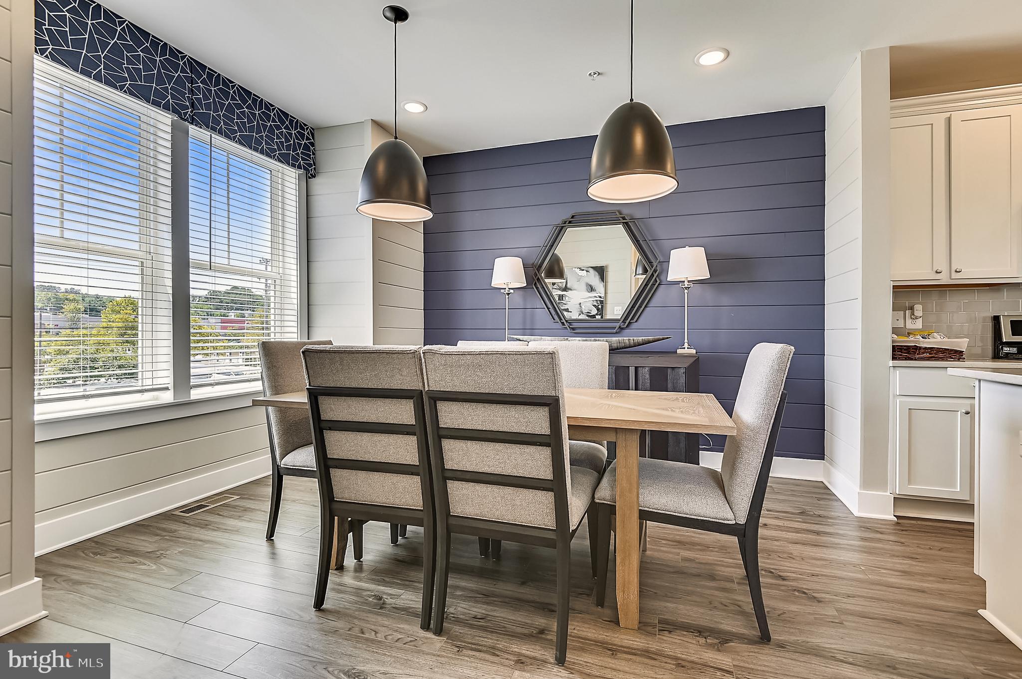 16605 Breezeway Alley Accokeek, MD 20607 - Photo 6 of 34 a dining room with wooden floor a chandelier a wooden table and chairs