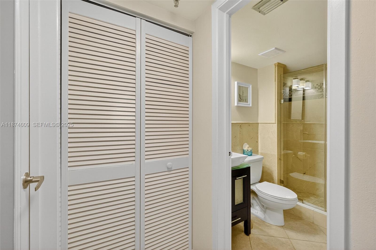 2401 Collins Avenue, Unit 1005 Miami Beach, FL 33140 - Photo 9 of 19 a bathroom with a toilet a sink and shower