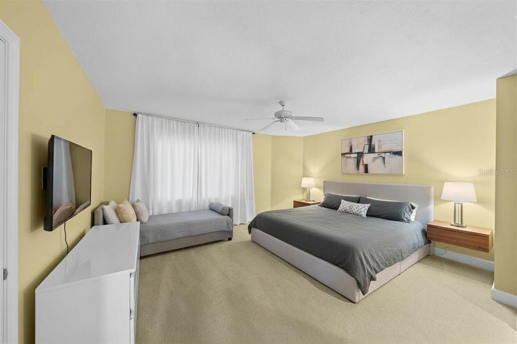 4575 South Atlantic Avenue, Unit 6209 Ponce Inlet, FL 32127 - Photo 17 of 31 a bedroom with a bed and a flat screen television