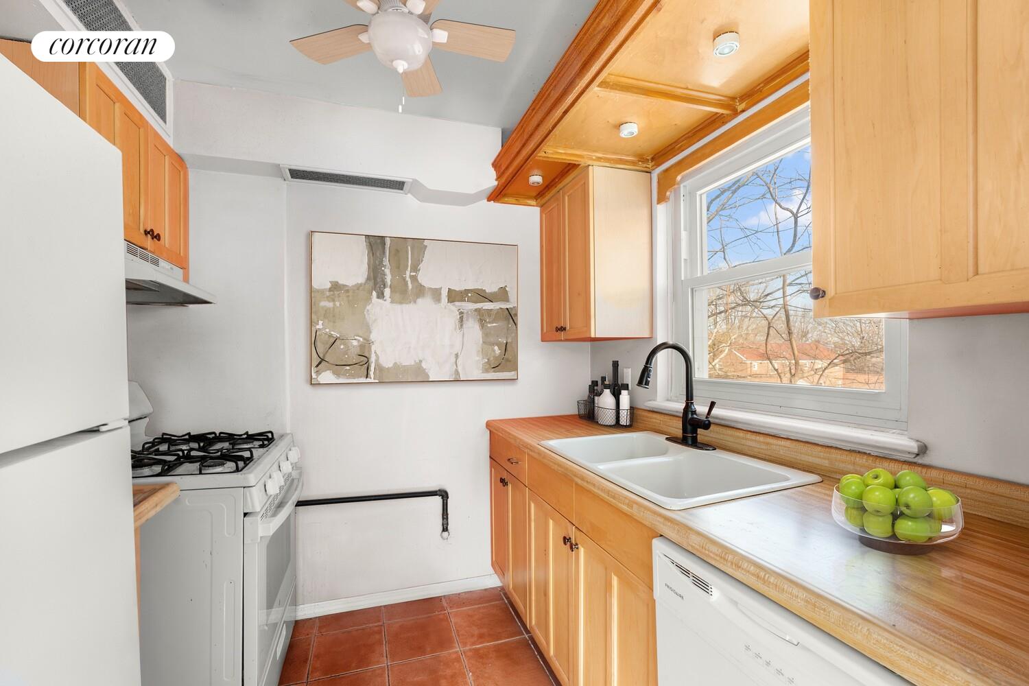 147-36 Charter Road, Unit 34E Queens, NY 11435 - Photo 12 of 14 a kitchen with stainless steel appliances granite countertop a sink and a window