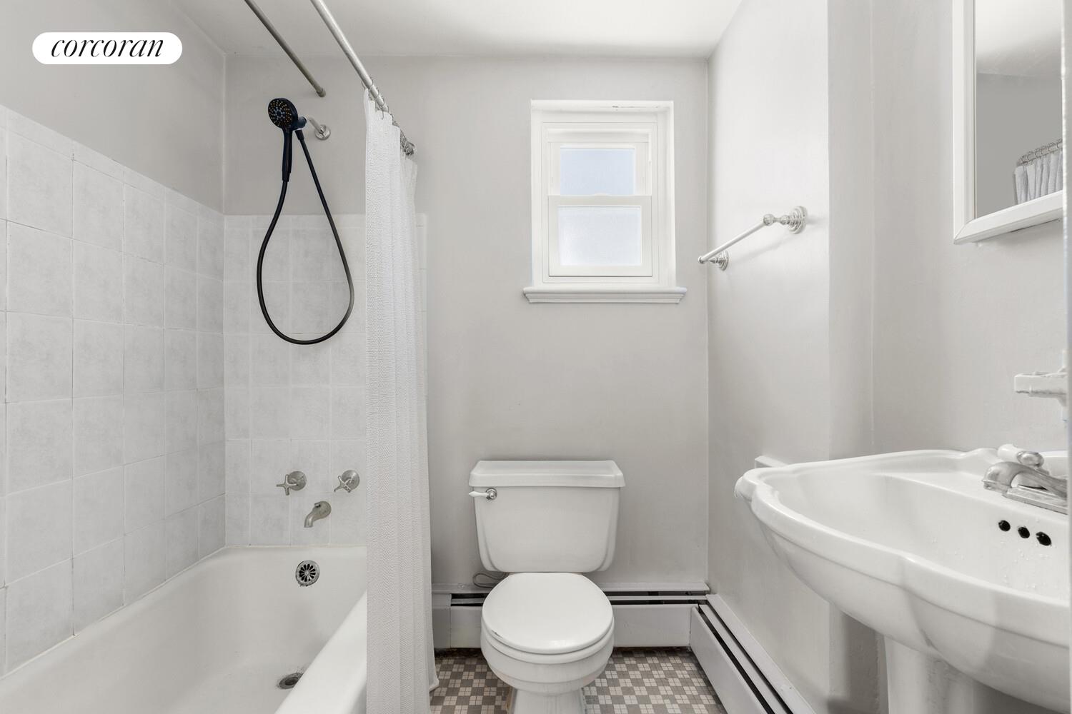 147-36 Charter Road, Unit 34E Queens, NY 11435 - Photo 9 of 14 a bathroom with a sink a toilet and a bathtub