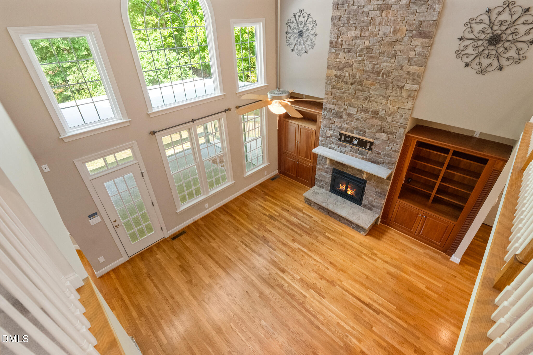 3209 Nimich Pond Way Raleigh, NC 27613 - Photo 11 of 78 Dramatic two-story family room with soaring ceilings and a stunning floor-to-ceiling stone fireplace with custom built-ins