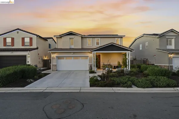 a hallway with wooden floor closet and livingroom view