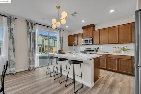 a balcony with furniture and a view of kitchen