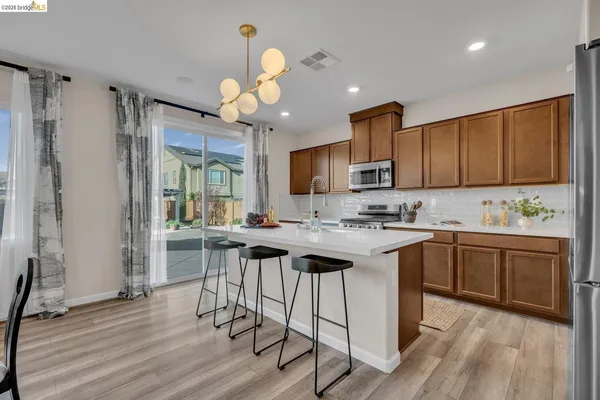 a balcony with furniture and a view of kitchen