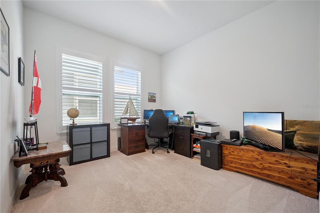 17588 Lake Star Road Winter Garden, FL 34787 - Photo 11 of 57 a view of a workspace with furniture and a window