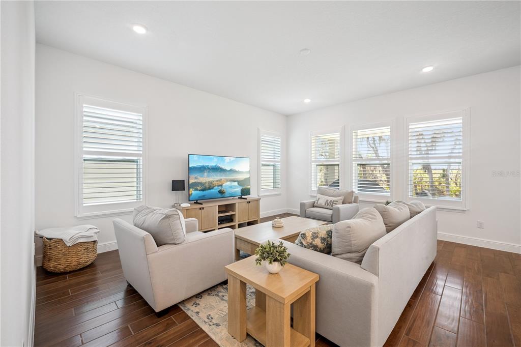 17588 Lake Star Road Winter Garden, FL 34787 - Photo 12 of 57 a living room with furniture and a flat screen tv