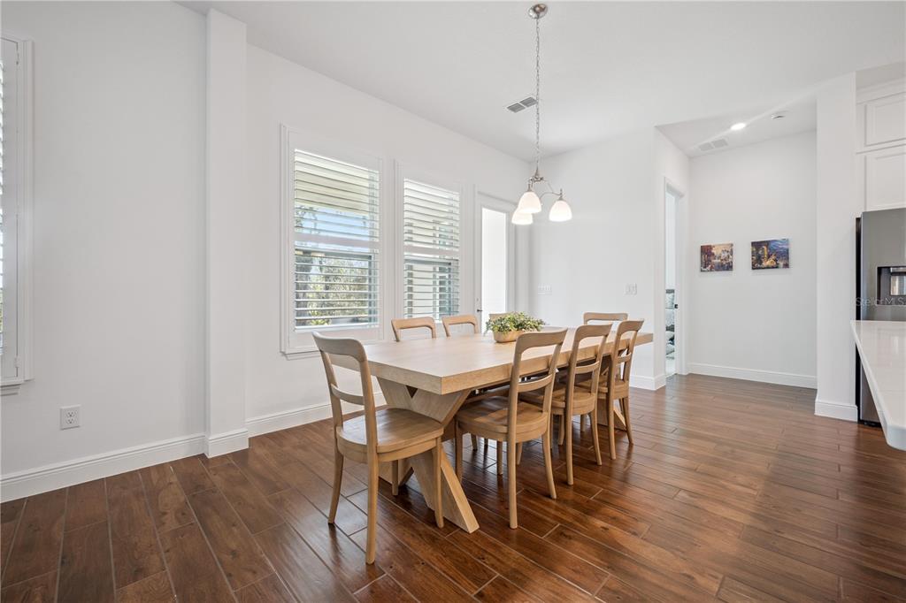 17588 Lake Star Road Winter Garden, FL 34787 - Photo 13 of 57 a view of a dining room with furniture window and wooden floor
