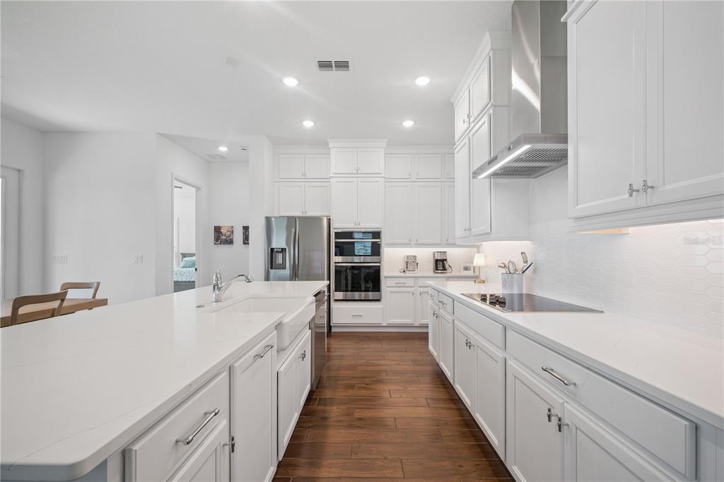 17588 Lake Star Road Winter Garden, FL 34787 - Photo 15 of 57 a large white kitchen with a large window a sink and stainless steel appliances