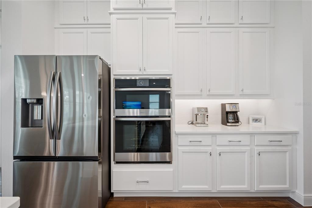 17588 Lake Star Road Winter Garden, FL 34787 - Photo 16 of 57 a kitchen with stainless steel appliances white cabinets and a refrigerator