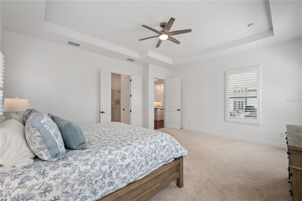 17588 Lake Star Road Winter Garden, FL 34787 - Photo 18 of 57 a bedroom with a large bed and a window