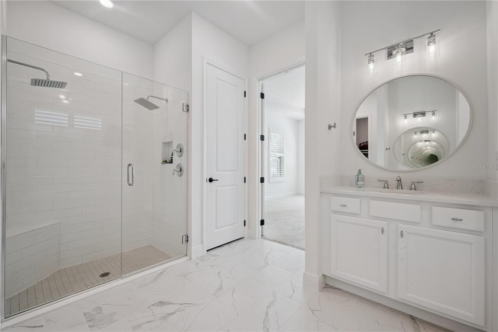 17588 Lake Star Road Winter Garden, FL 34787 - Photo 20 of 57 a bathroom with a mirror a sink and shower