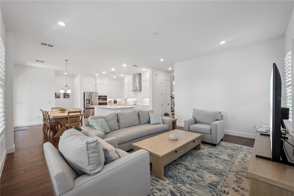 17588 Lake Star Road Winter Garden, FL 34787 - Photo 2 of 57 a living room with furniture kitchen view and a flat screen tv
