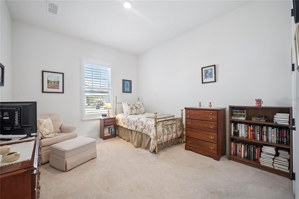 17588 Lake Star Road Winter Garden, FL 34787 - Photo 24 of 57 a bed room with furniture and a book shelf