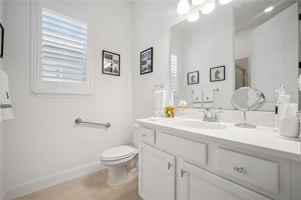 17588 Lake Star Road Winter Garden, FL 34787 - Photo 25 of 57 a bathroom with a toilet a sink and mirror