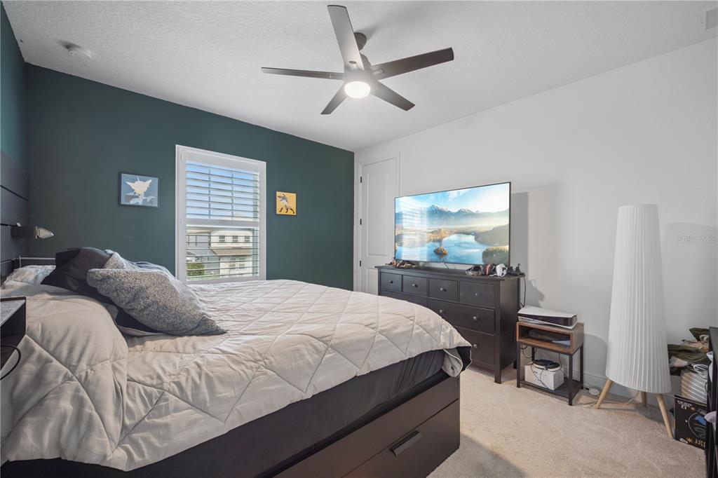 17588 Lake Star Road Winter Garden, FL 34787 - Photo 34 of 57 a bedroom with a bed and a flat tv screen on dresser