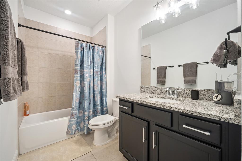 17588 Lake Star Road Winter Garden, FL 34787 - Photo 35 of 57 a bathroom with a granite countertop sink toilet and shower