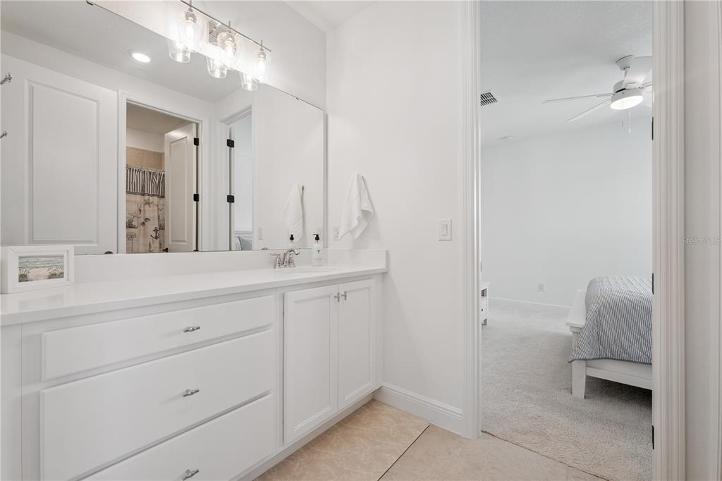 17588 Lake Star Road Winter Garden, FL 34787 - Photo 37 of 57 a bathroom with a double vanity sink toilet and a mirror