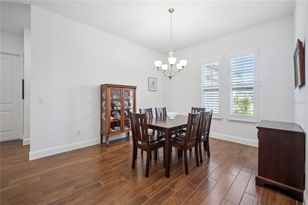 17588 Lake Star Road Winter Garden, FL 34787 - Photo 9 of 57 a view of a dining room with furniture window and wooden floor