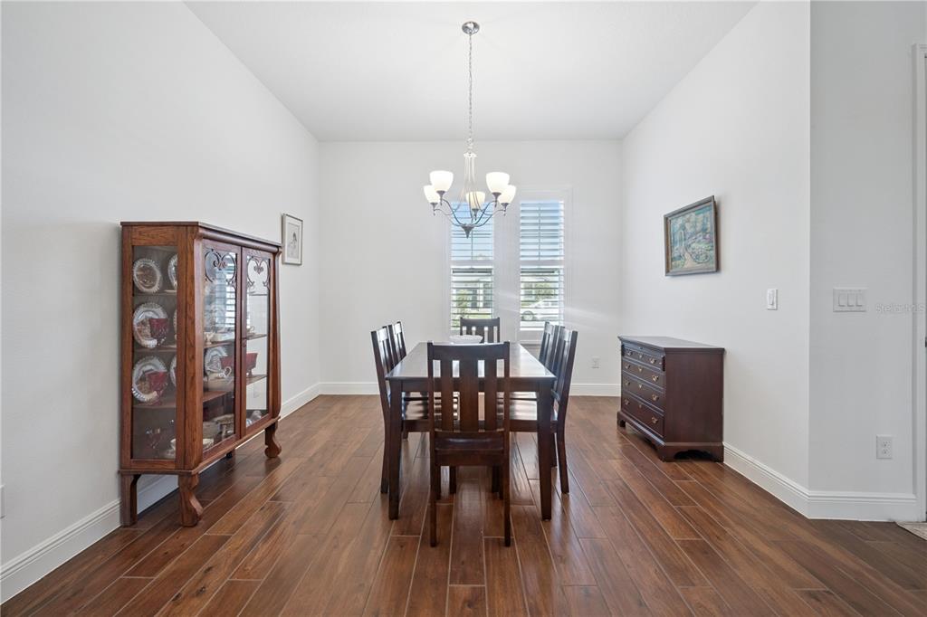 17588 Lake Star Road Winter Garden, FL 34787 - Photo 10 of 57 a view of a dining room with furniture window and wooden floor