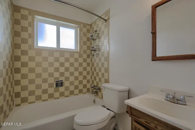 a backyard of a house with yard table and chairs