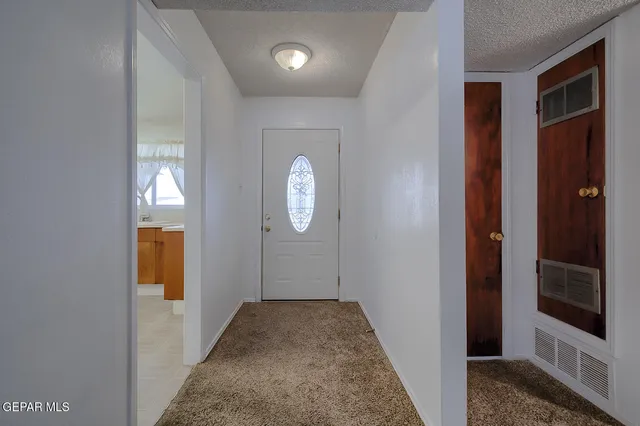 a view of a hallway with wooden floor and windows