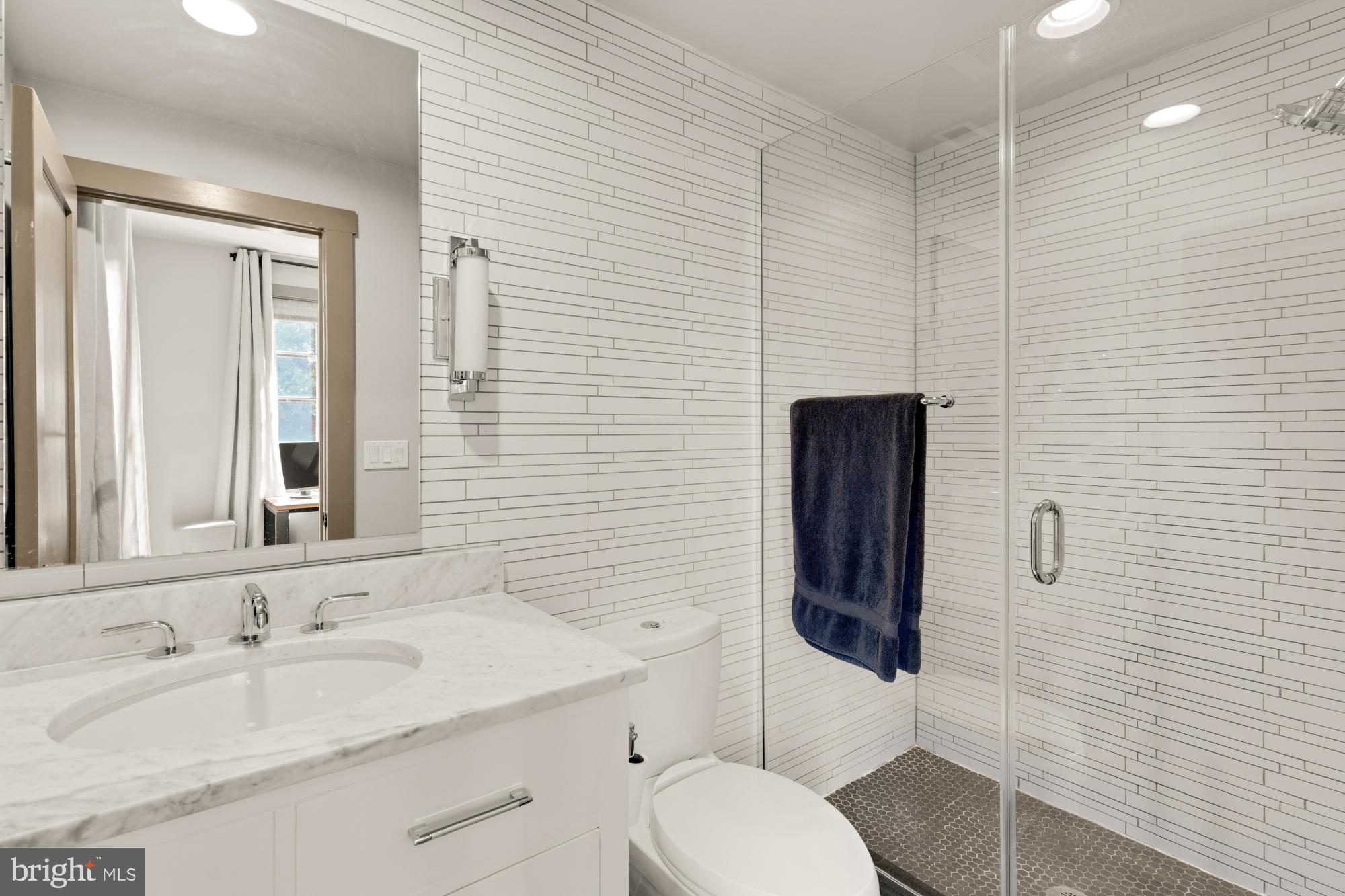 3220 Grace Street Northwest, Unit 5 Washington, DC 20007 - Photo 11 of 19 a bathroom with a granite countertop sink toilet and shower