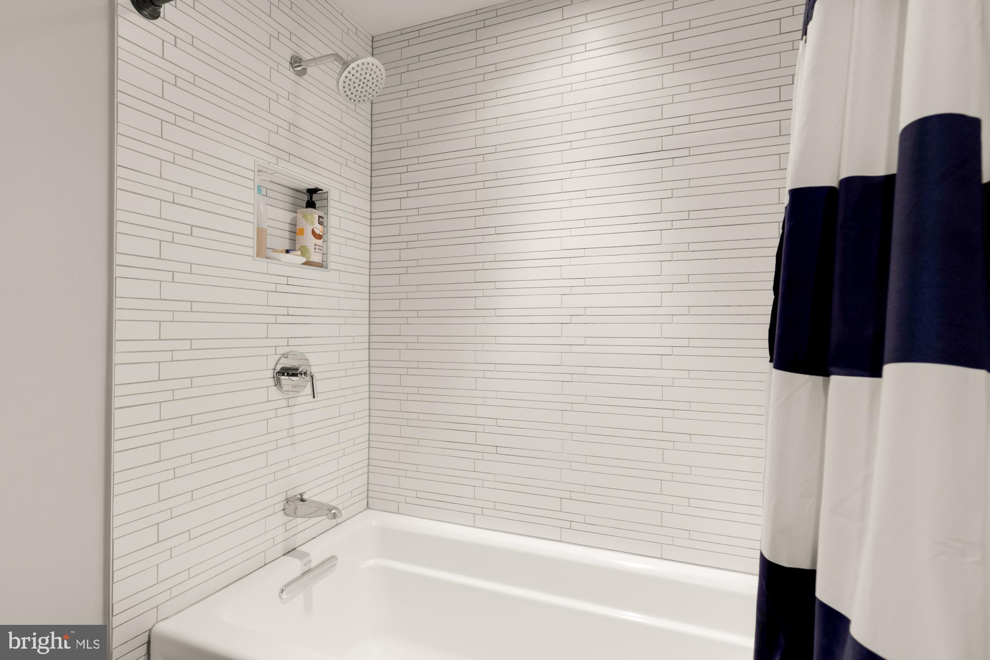 3220 Grace Street Northwest, Unit 5 Washington, DC 20007 - Photo 15 of 19 a bathroom with a bathtub and a shower