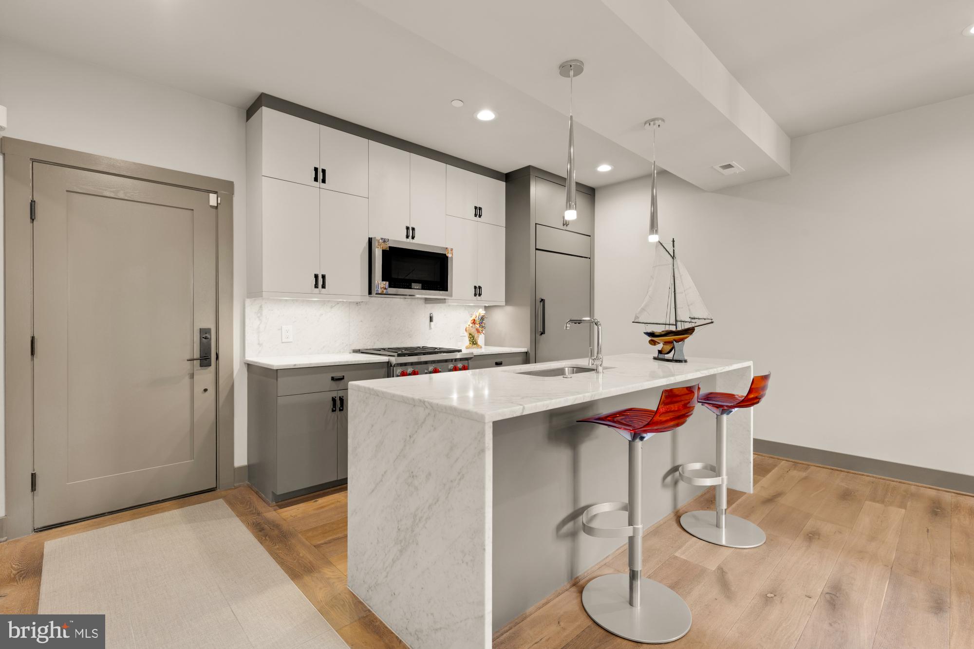3220 Grace Street Northwest, Unit 5 Washington, DC 20007 - Photo 2 of 19 a kitchen with a sink cabinets and wooden floor