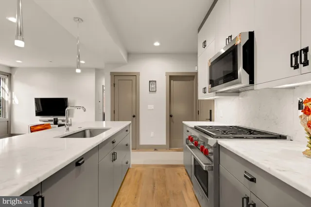 a kitchen that has a lot of cabinets and appliances