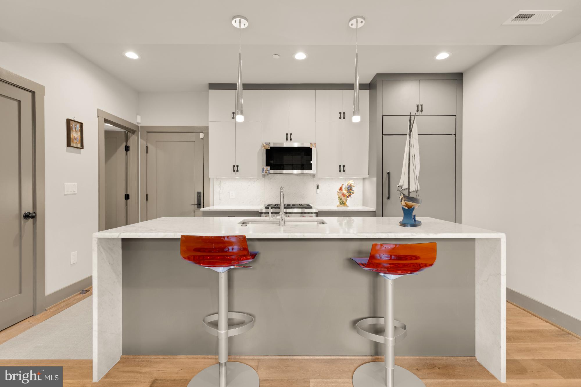 3220 Grace Street Northwest, Unit 5 Washington, DC 20007 - Photo 5 of 19 a kitchen with stainless steel appliances granite countertop a sink and a refrigerator