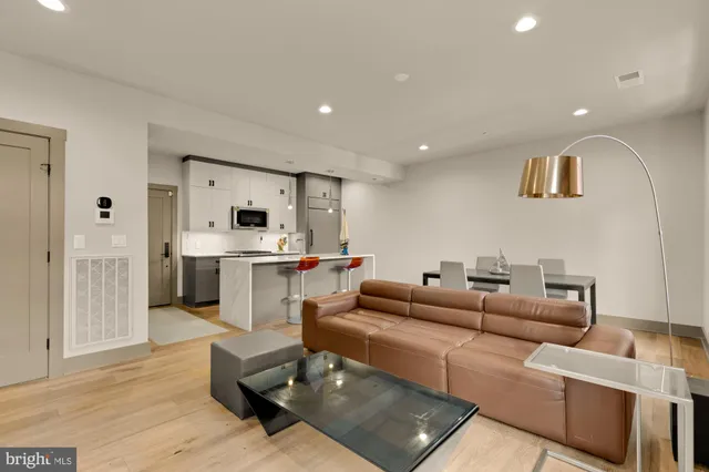 a living room with furniture and kitchen view