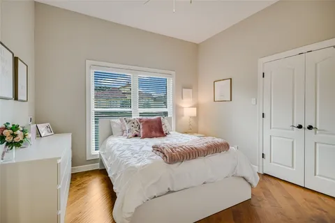 a bedroom with a bed table and a window