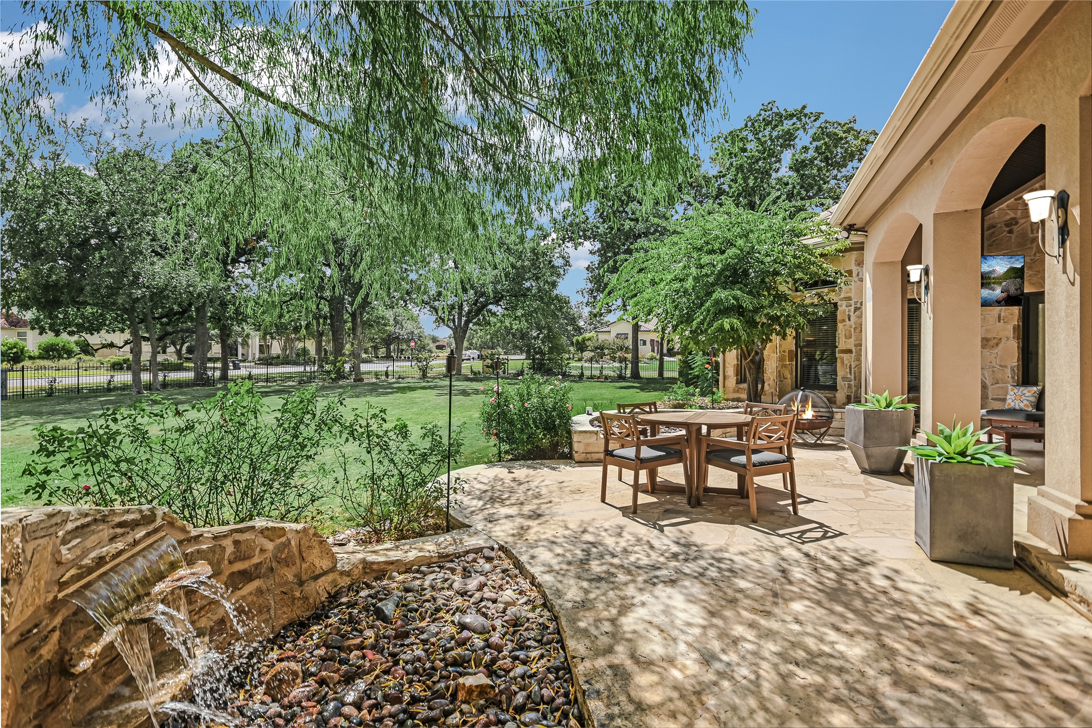 100 Dovetail Lane Georgetown, TX 78628 - Photo 23 of 34 a view of a patio with table and chairs potted plants and a large tree