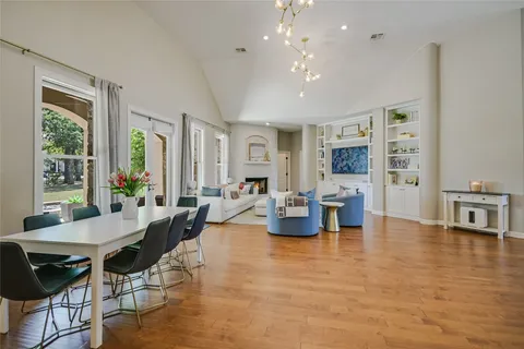 a living room with fireplace furniture and a large window