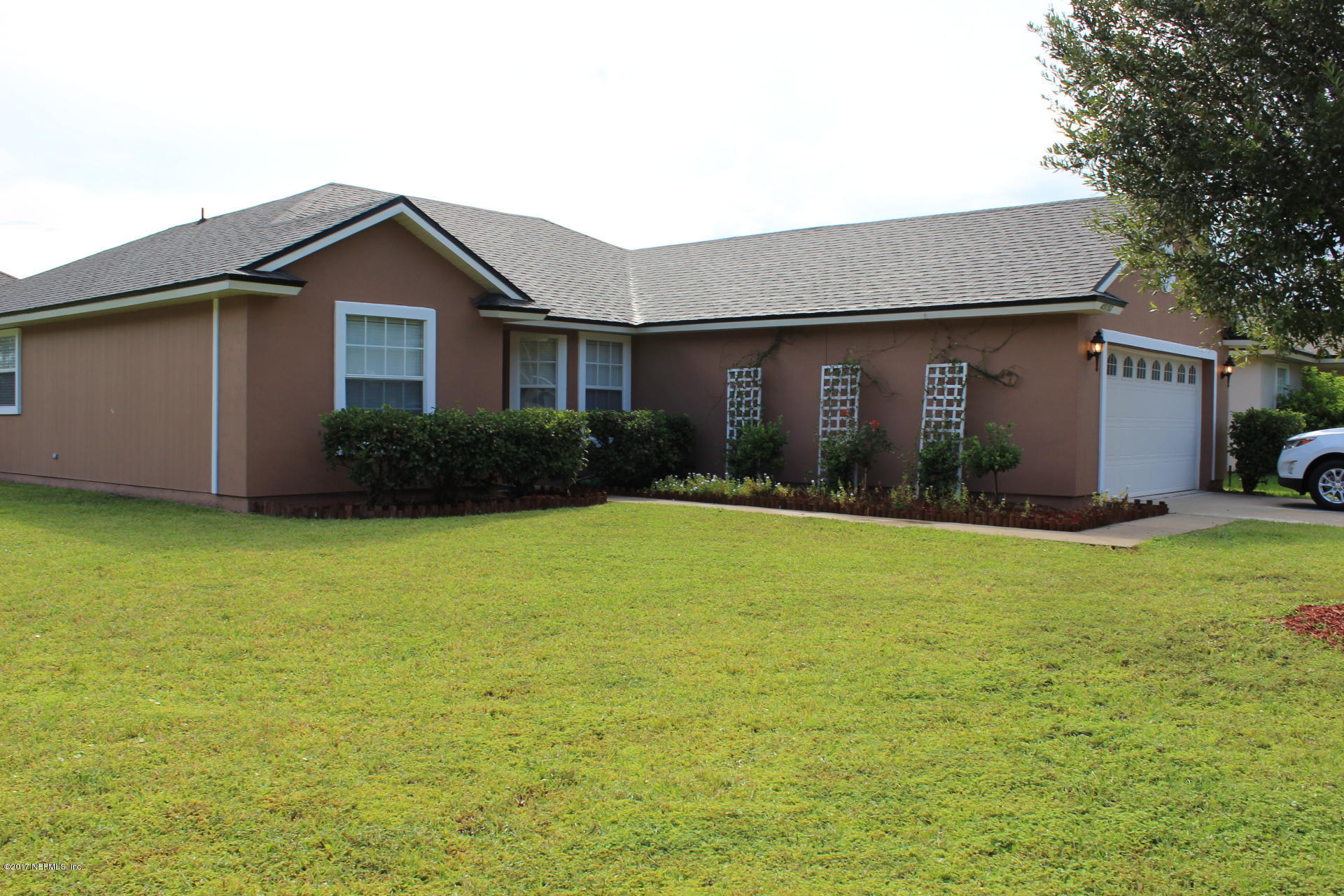 a front view of house with yard and green space