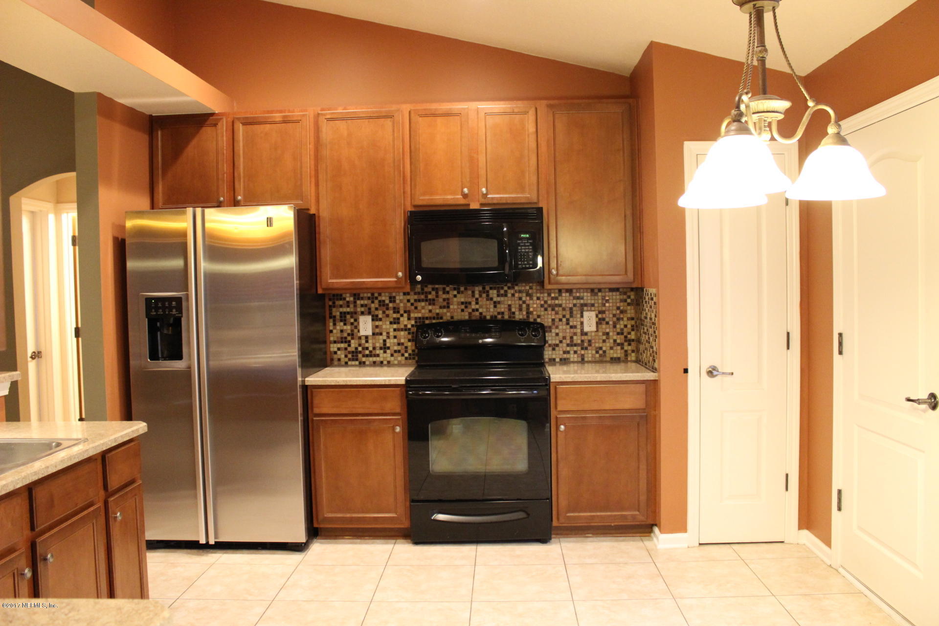 45157 Ingleham Circle Callahan, FL 32011 - Photo 14 of 27 a kitchen with a refrigerator and a sink