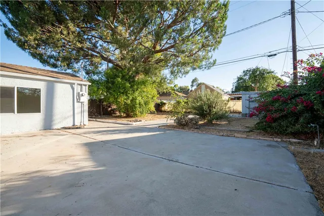 a front view of a house with a yard and a garden