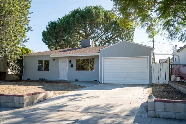 a house that has a tree in front of the house