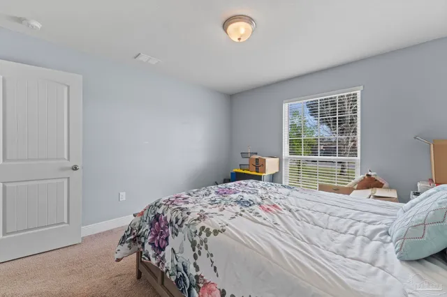 a bedroom with a bed and a window