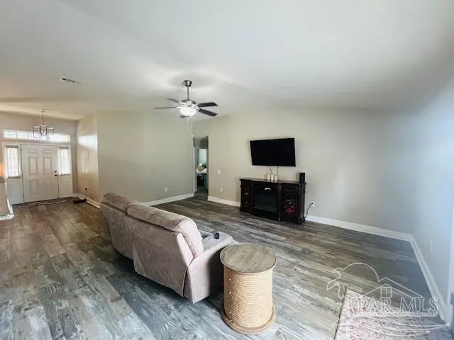 a living room with furniture and a flat screen tv