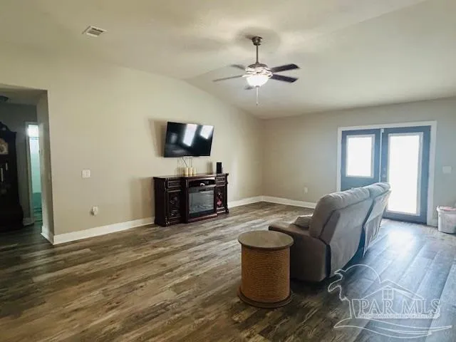 a living room with furniture and a flat screen tv
