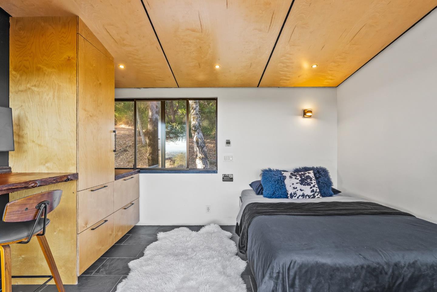 579 San Juan Pass Road Corralitos, CA 95076 - Photo 20 of 56 a bedroom with a bed a window and flowerpot