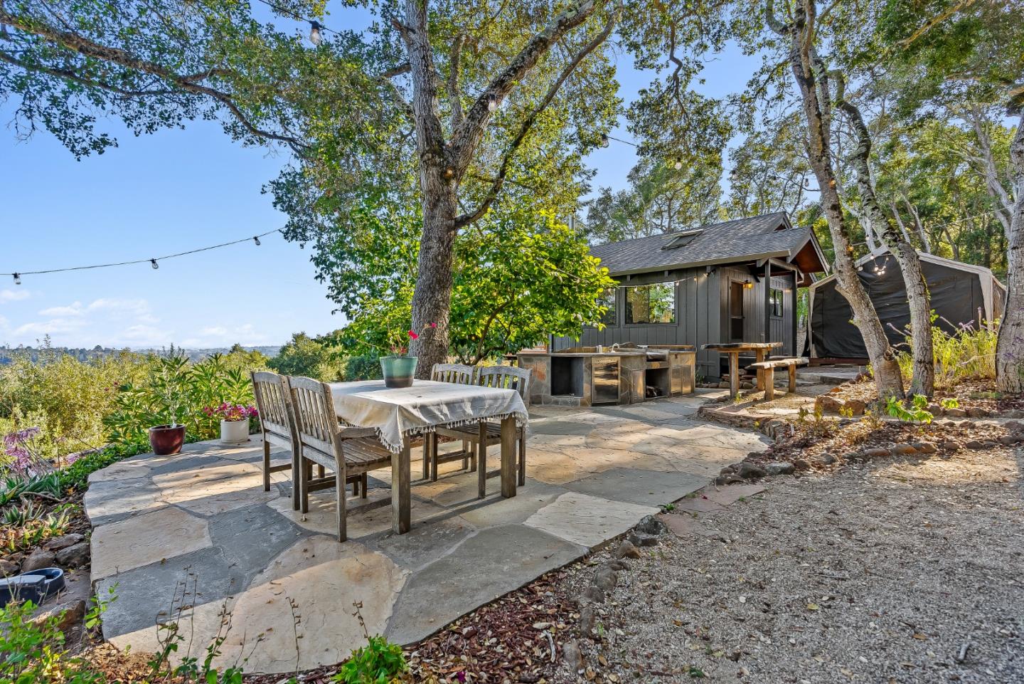 579 San Juan Pass Road Corralitos, CA 95076 - Photo 33 of 56 a view of a patio with table and chairs with wooden fence and plants