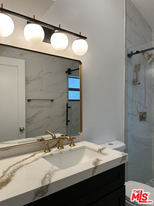 17209 Keswick Street Lake Balboa, CA 91406 - Photo 11 of 19 a bathroom with a sink and a mirror