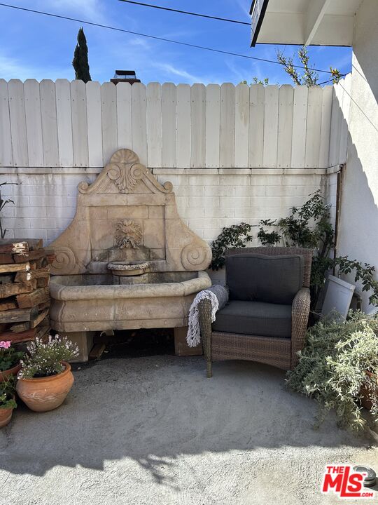 17209 Keswick Street Lake Balboa, CA 91406 - Photo 17 of 19 a bath room with a couch and a potted plant