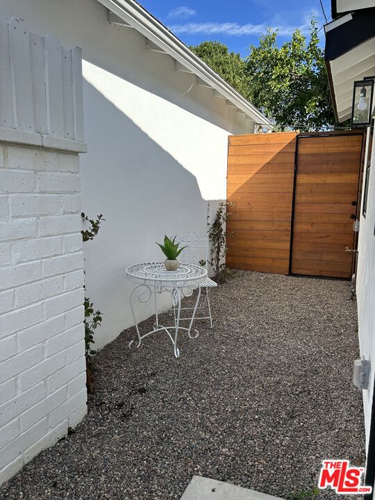 17209 Keswick Street Lake Balboa, CA 91406 - Photo 18 of 19 a backyard of a house with table and chairs