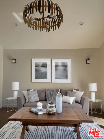 a bedroom with a bed and painting on the wall